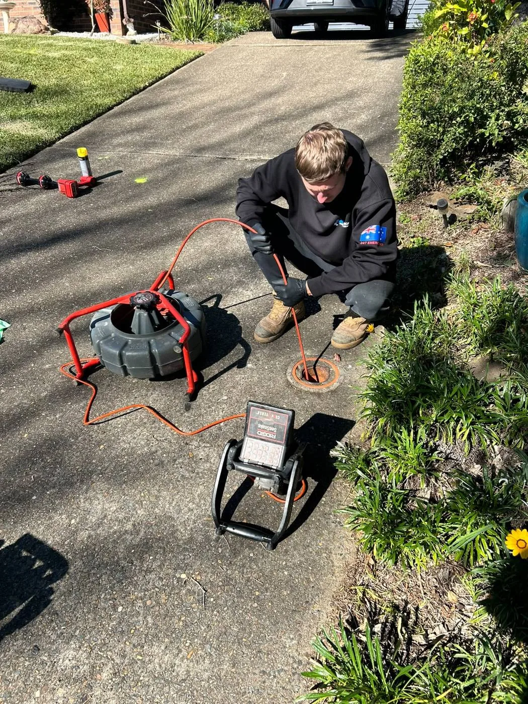 Drain camera inspection set up on a driveway