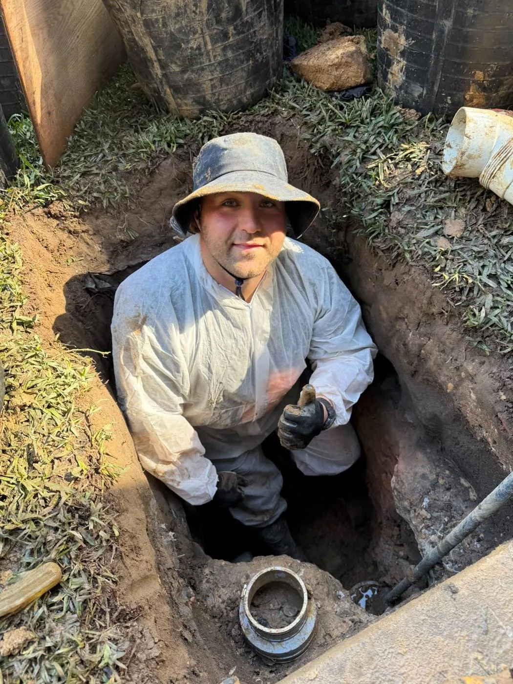 Sewer pipe repair in a hand-dug excavation