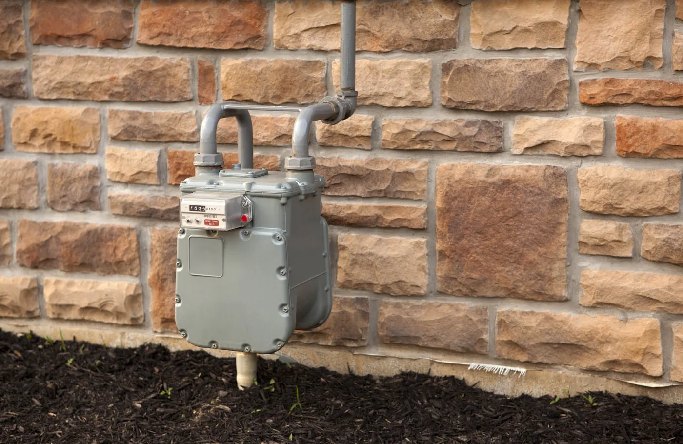 Gas meter mounted on a brick wall