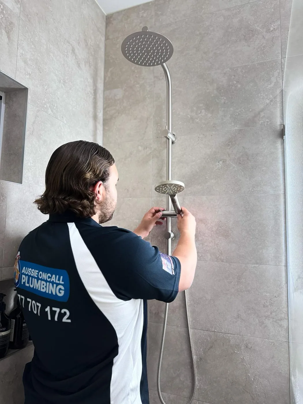 Plumber fitting a new shower head